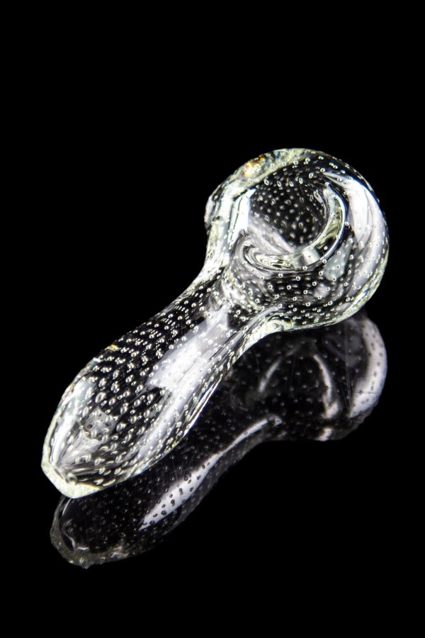 Glass cannabis pipe with speckled pattern and reflective surface.