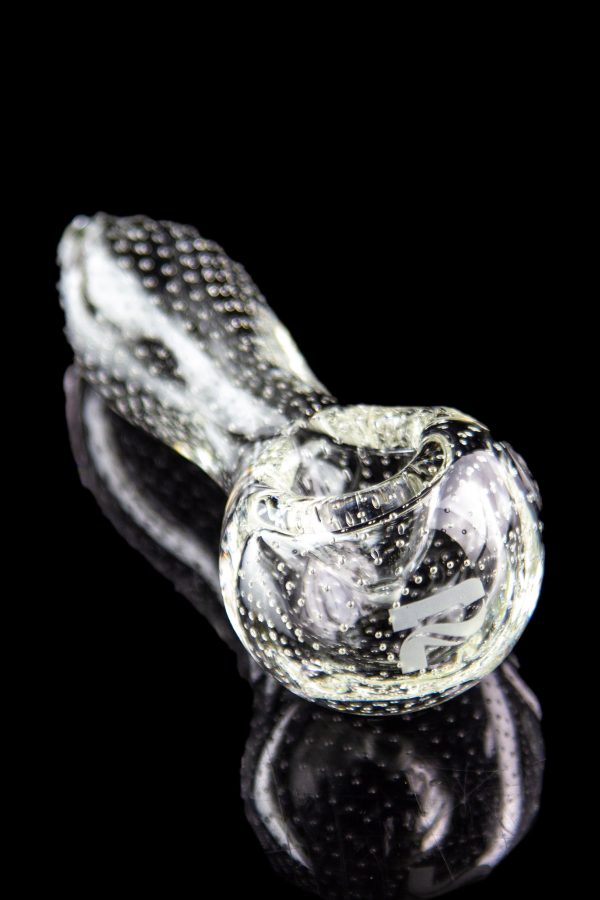 Clear glass pipe with textured surface and reflective black background.