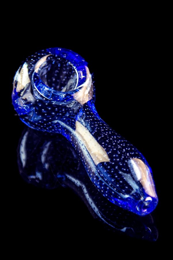 A side view of the Pulsar Bubble Matrix Spoon Pipe, showing a blue glass pipe with a speckled pattern against a black background.