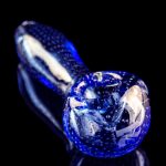 Blue glass pipe with bubbling texture, studio shot.