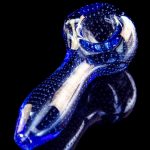 Blue glass pipe with white speckled accents, isolated on black.