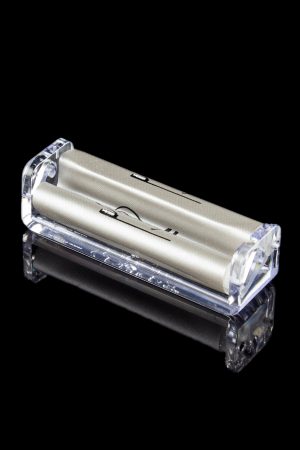 Clear acrylic rolling machine for making cigarettes, isolated on a black background.