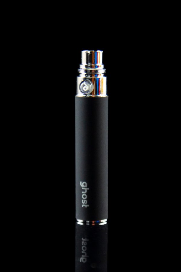 Black "Ghost" branded vaporizer pen with a colorful glass mouthpiece, reflecting on a dark surface.