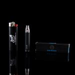Black cannabis oil vaporizer pen and packaging on a reflective surface.