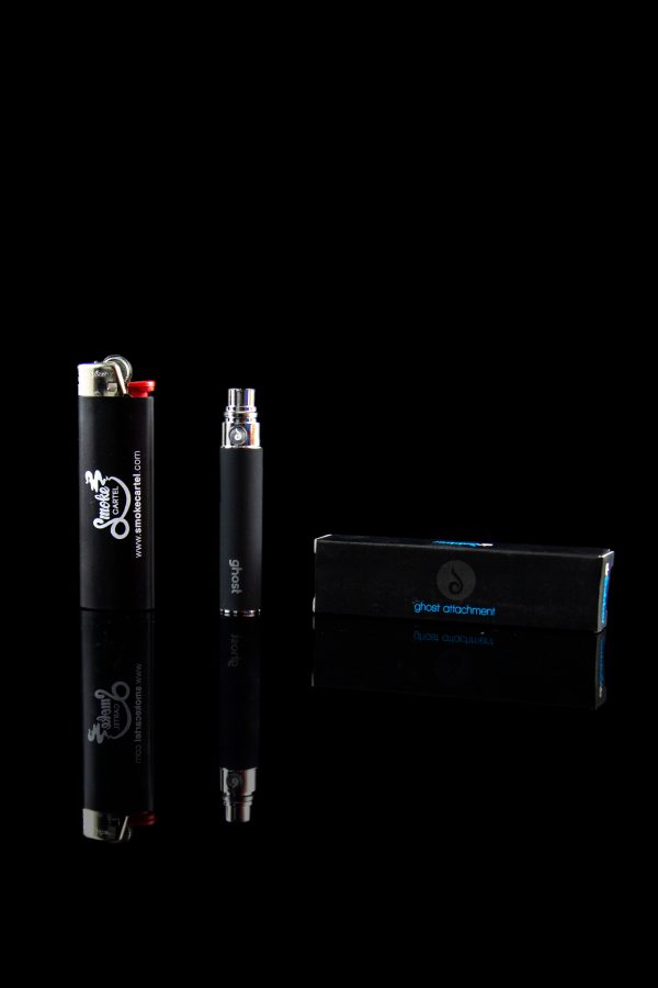 Black cannabis oil vaporizer pen and packaging on a reflective surface.