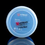 Close-up of a blue “Lucky Bear” cannabis vape cartridge cap with branding and age restriction warning, reflected on a glossy surface.