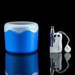 Blue cannabis storage container and silver vape pen with white earbuds reflected on a glossy black surface.