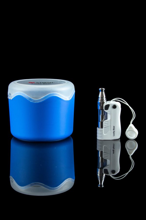 Blue cannabis storage container and silver vape pen with white earbuds reflected on a glossy black surface.