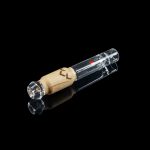 Glass pipe with a wooden mouthpiece, isolated on black.