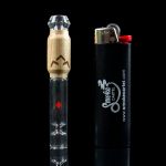 Glass cannabis pipe with a wooden mouthpiece and a black lighter displaying a cannabis leaf logo.