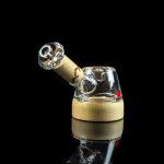 A glass cannabis rig with a wooden accent, isolated on a black reflective surface.