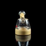 Glass rig for dabbing cannabis, studio shot on a reflective surface.