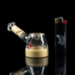 Glass bubbler water pipe and lighter on a reflective surface.