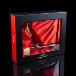 Red gift box containing a glass cannabis pipe on red silk, with branding for “Canada Puffin.”