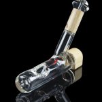 Glass bubbler pipe with intricate white and gray swirls, reflecting on a dark surface.