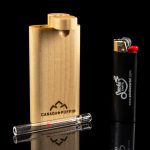 Glass bubbler pipe inside a black carrying case next to a lighter, branded with “Canada Puffin” and “Smoke Cartel.”