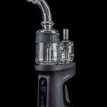 Black and glass electronic dab rig (e-rig) with digital display, studio shot.