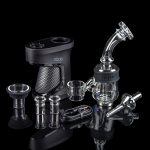 A black doob e-nail with various glass water pipes and attachments displayed on a black surface.