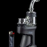 A black DaVinci IQ2 vaporizer with a glass water pipe attachment and a branded lighter.
