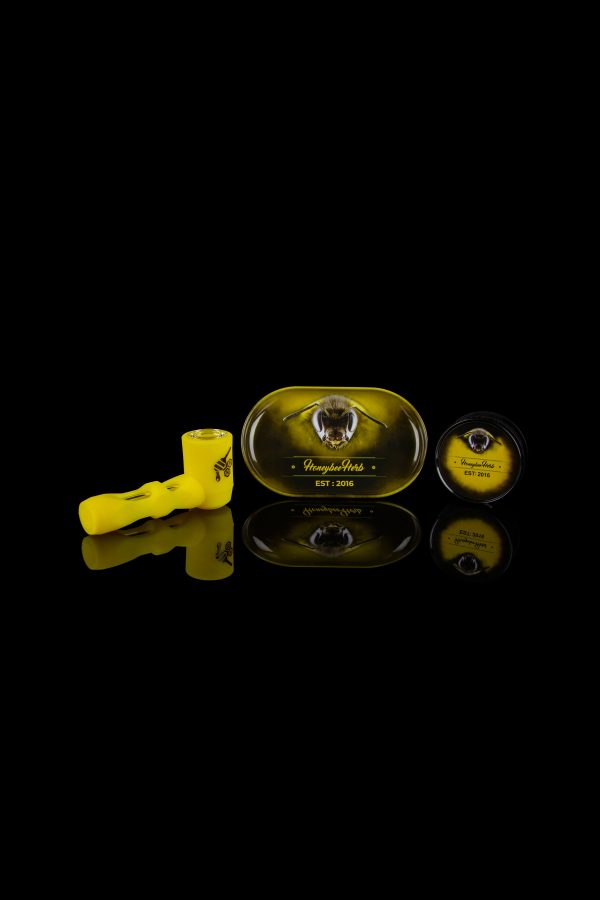 Cannabis oil syringe and branded cartridge packaging with reflective surface.