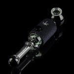 Black glass oil rig with a textured sleeve, illuminated against a dark reflective surface.