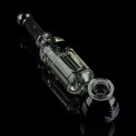 Clear glass oil rig with intricate design against a black background.