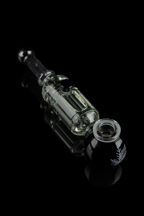 Clear glass oil rig with intricate design against a black background.