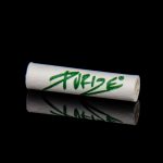 Rolled cannabis filter tips with green “Pure” logo reflected on a dark surface.