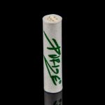 White pre-rolled cone with green “Pridel” branding, reflecting on a glossy black surface.