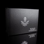 Black box for a cannabis mini dab rig, featuring a snowflake design and website address.