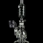 Clear glass water pipe (rig) with a quartz banger, isolated on a black background.