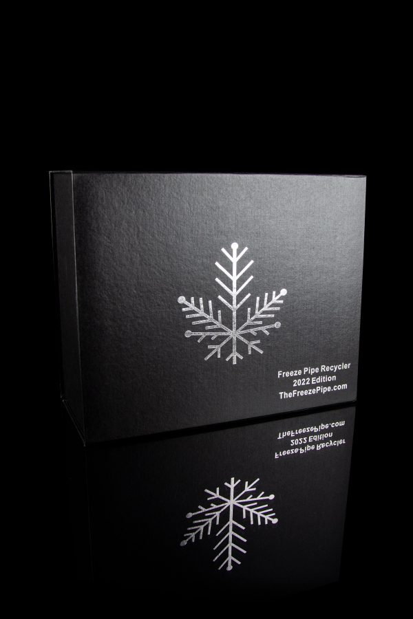 Black box with silver snowflake design and text advertising "Freeze Pipe Recycler" and website "TheFreezePipe.com".