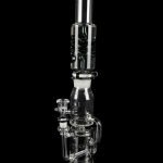 Clear glass water pipe (bong) with multiple chambers and a glass bowl, isolated on a black background.