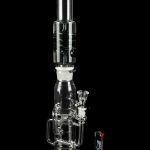 Clear glass water pipe (bong) with intricate branching percolators, studio shot on a reflective surface.