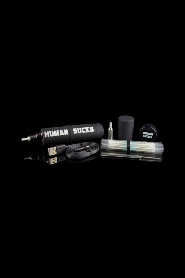 Cannabis vaping kit with pen, charger, and accessories on a black background, branded with “HUMAN SUCKS.”