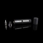 Cannabis oil vape pen components displayed on a black background with "HUMAN SUCKS" printed on the battery.