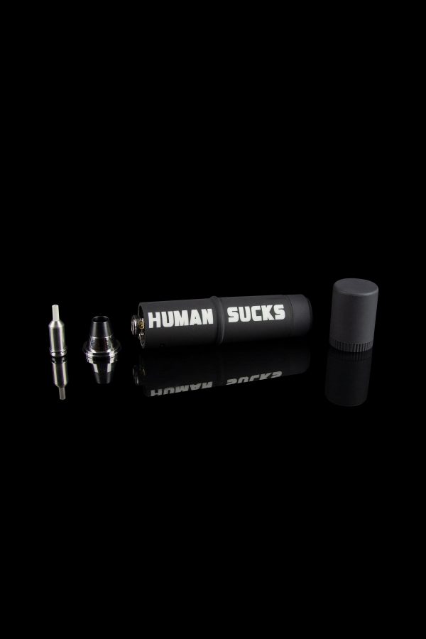 Cannabis oil vape pen components displayed on a black background with "HUMAN SUCKS" printed on the battery.