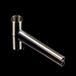 Silver cannabis oil burner pipe against a black background.