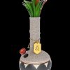 A decorative glass bong resembling a vase, adorned with faux botanical sprigs and a label reading “My Bud Vase.”"