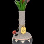 A decorative glass bong resembling a vase, adorned with faux botanical sprigs and a label reading “My Bud Vase.”"