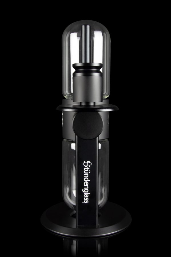 Sündglass black silicone nectar collector with glass tip, isolated on a black background.