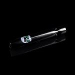 Black glass pipe with green cannabis leaf design, isolated on a dark background.