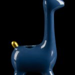 Blue ceramic llama pipe with gold accents, studio shot on a reflective surface."