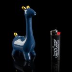 Blue ceramic giraffe water pipe with a branded lighter beside it, studio shot on a reflective black surface.