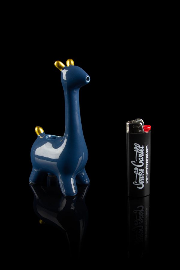 Blue ceramic giraffe water pipe with a branded lighter beside it, studio shot on a reflective black surface.