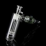 Clear glass bubbler and oil rig with intricate design, isolated on black.