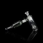 Clear glass rig with intricate bubbler and joint connection, isolated on black.