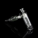 Clear glass water pipe (rig) with intricate bubbler design, isolated on black.