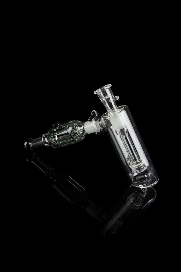 Clear glass water pipe (rig) with intricate bubbler design, isolated on black.