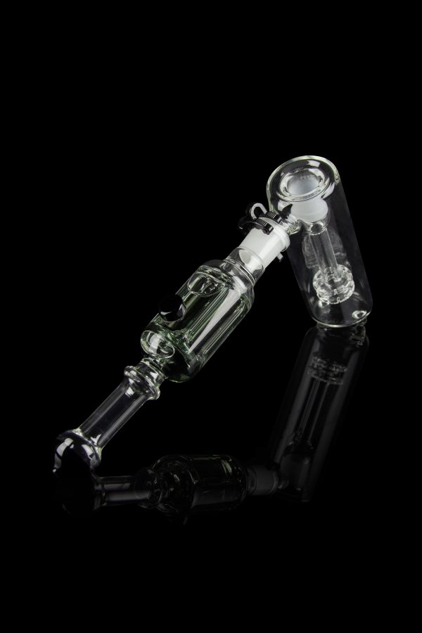 Clear glass oil rig with complex bubbler design, isolated on black.